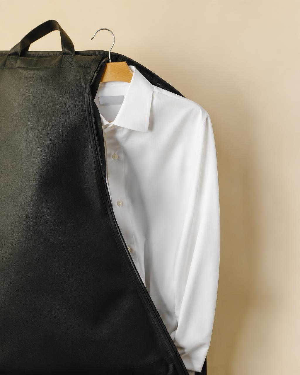 A freshly pressed white shirt in a garment bag
